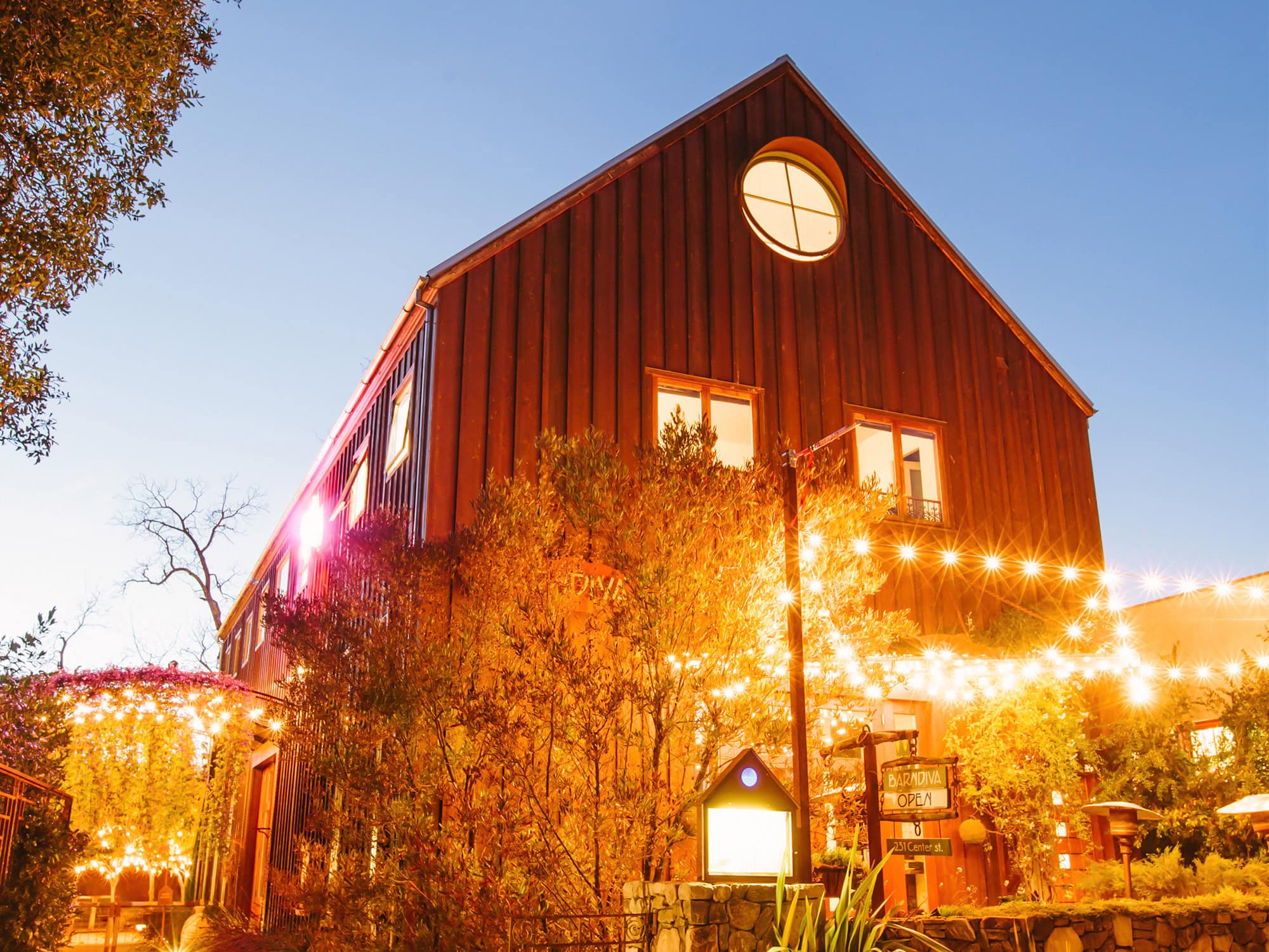 The exterior of the barn is lit up at night