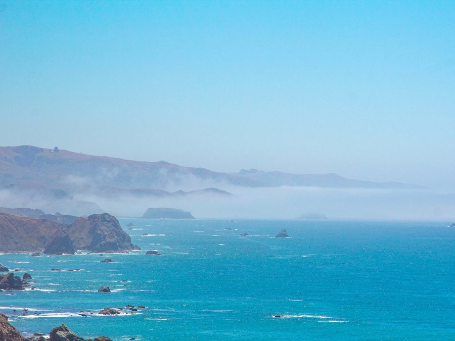 Fog clings along the rocky shore in Sonoma County