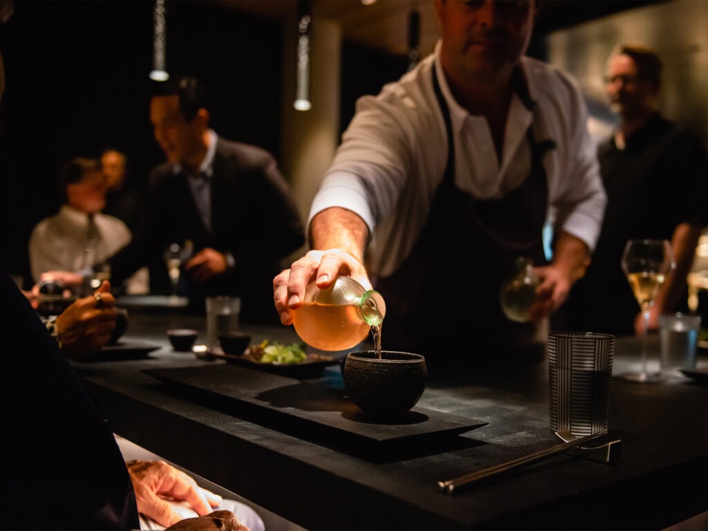 The restaurant server pouring a drink at Cyrus Restaurant in Geyserville.