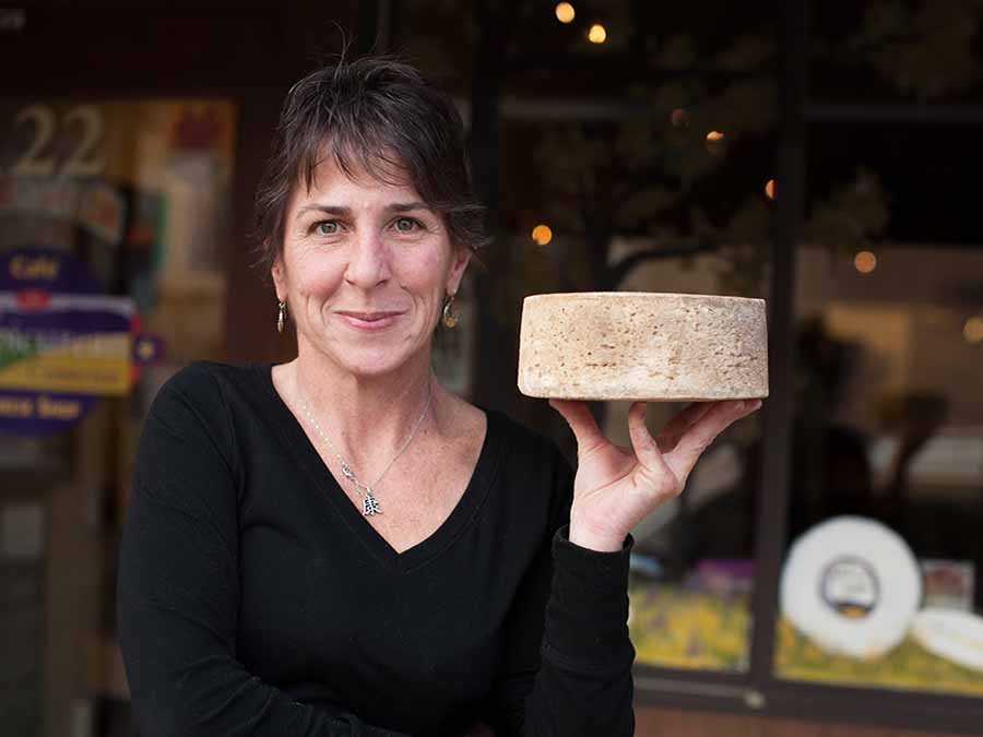 woman holding cheese in hand