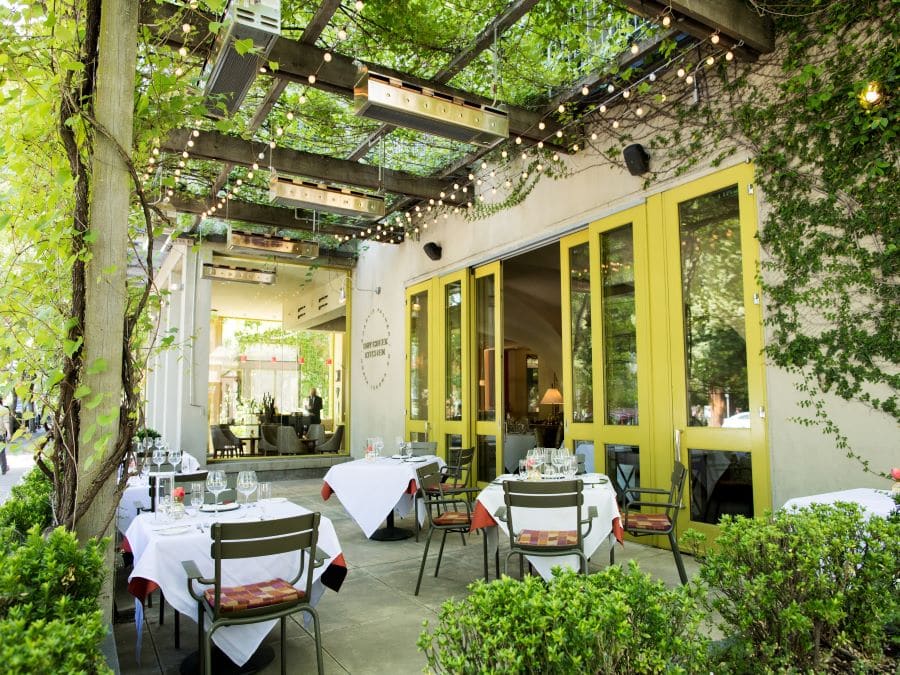 The patio has an arbor with trailing plants