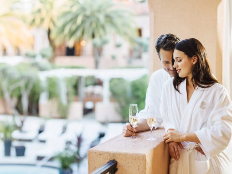 people enjoying champagne on a hotel balcony