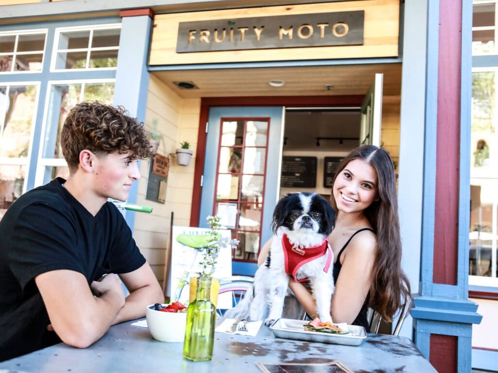 People with their dog eating outside of Fruity Moto in Windsor