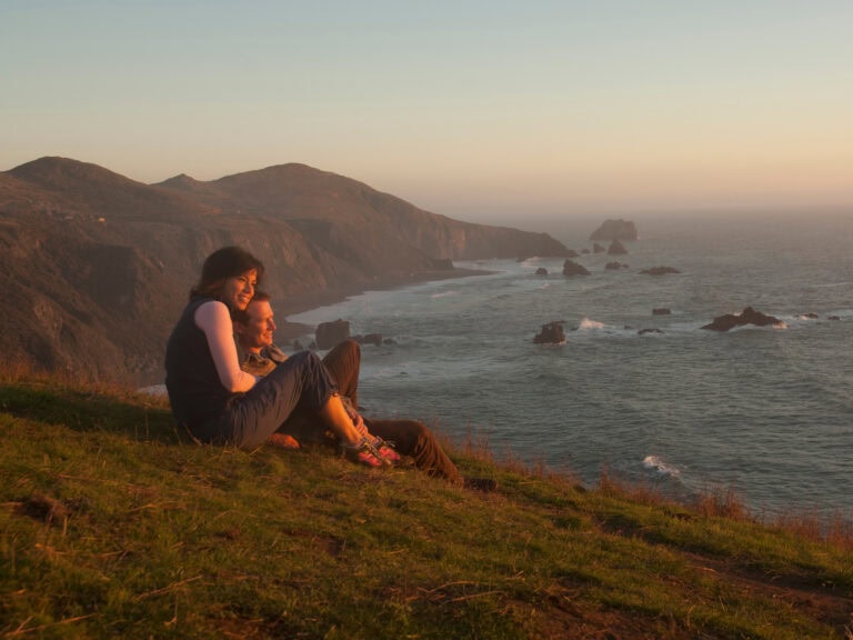 a couple enjoying the sunset at sonoma coast state park