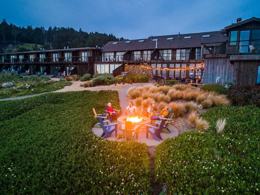 People sit around a firepit