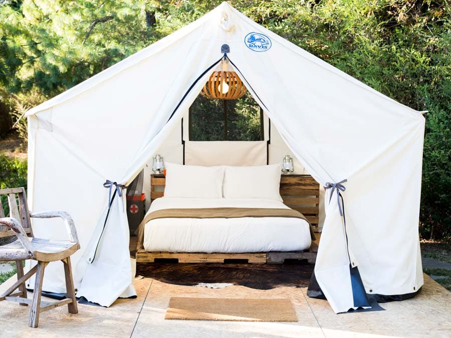 A luxurious glamping tent is surrounded by trees at boon hotel + spa, Guerneville