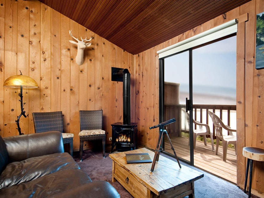 Wooden paneled hotel room on the coast with vintage decorations at River's End in Jenner