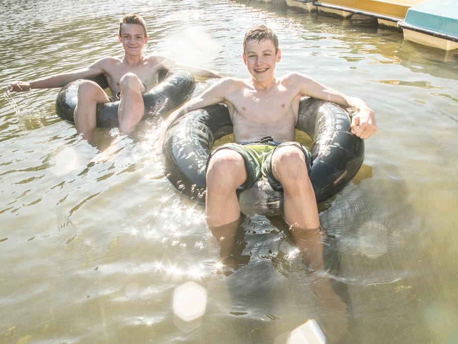 Two young men float in inner tubes in the Russian River at Johnson's Beach, Guerneville