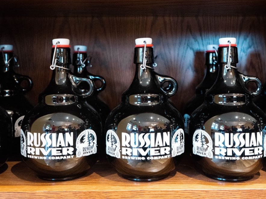 Pictures of growlers on shelf at Russian River Brewing