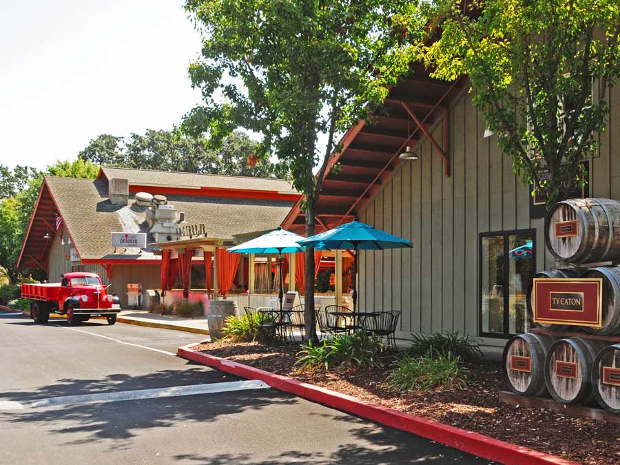 An antique, red truck sits outside of the restaurant and a tasting room