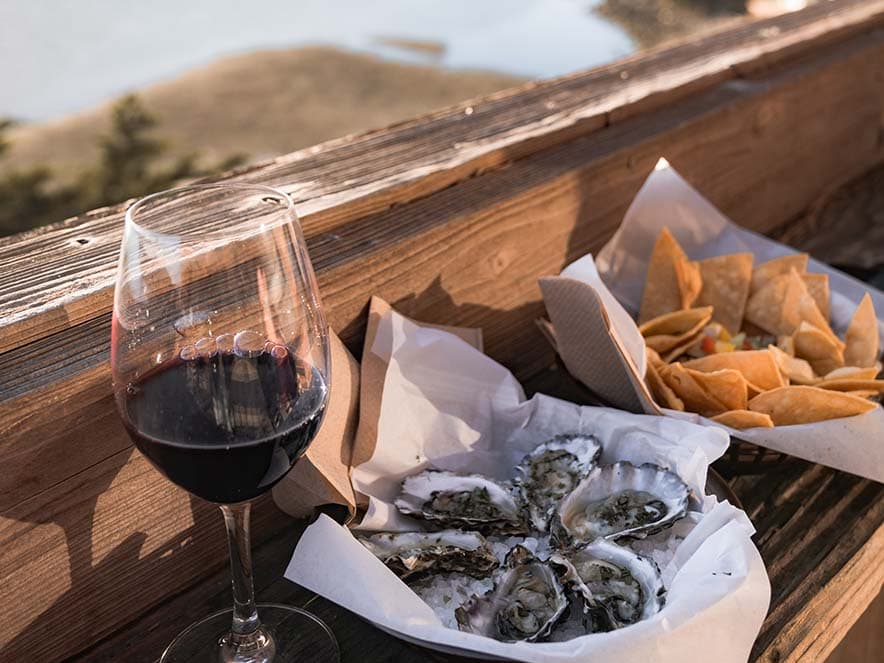 wine and oysters on deck overlooking water