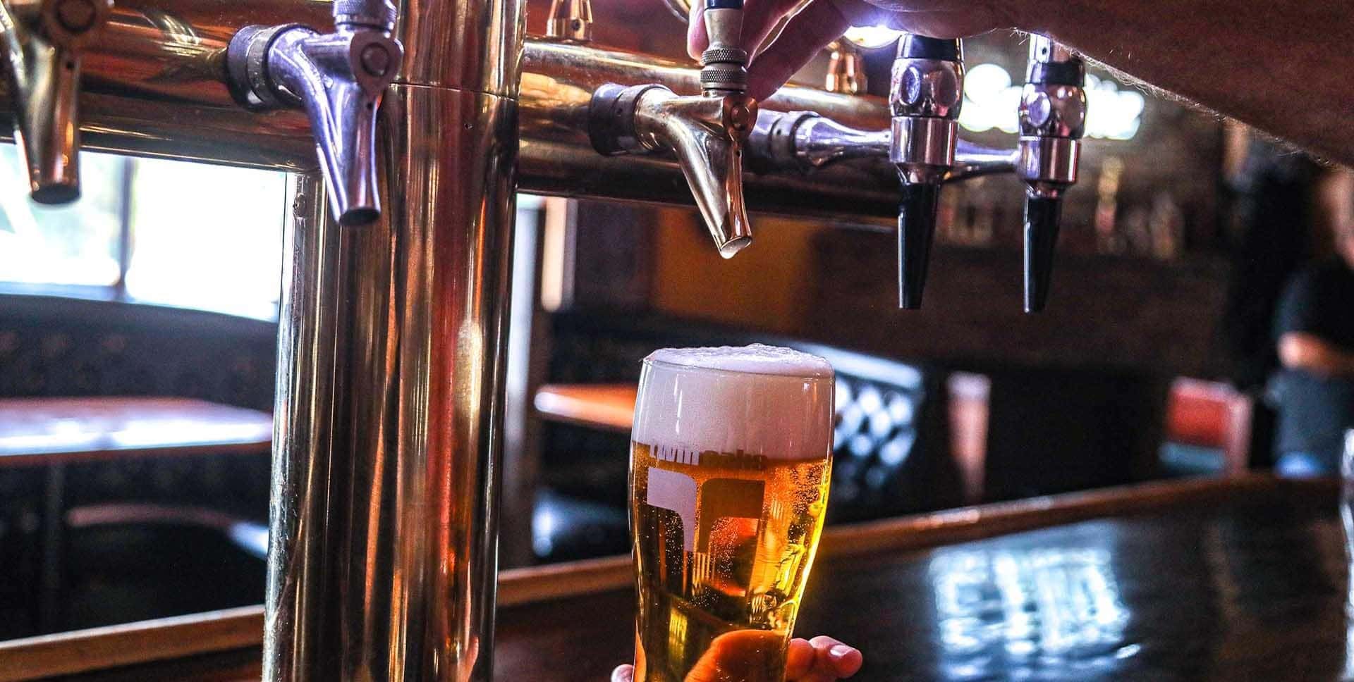 Beer being poured at the bar at Twin Oaks Roadhouse in Penngrove