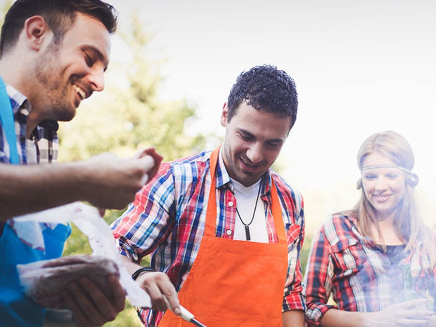 People stand around a BBQ grilling in Sonoma County