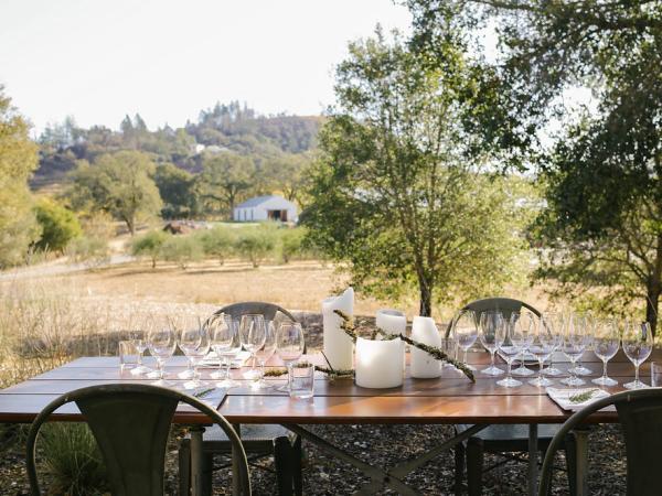 Picture of table of wine glasses overlooking vineyards