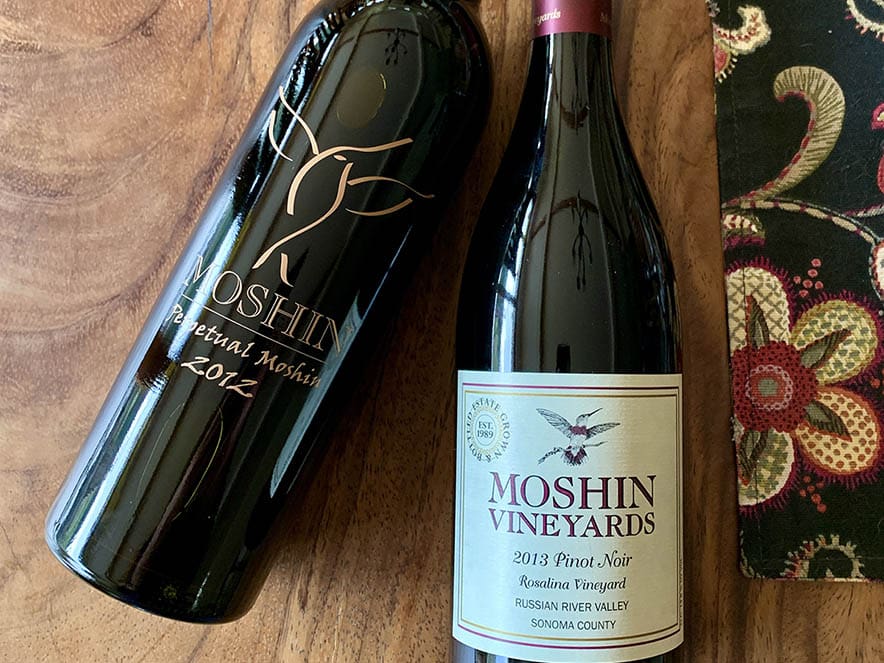 two moshin wine bottles with labels