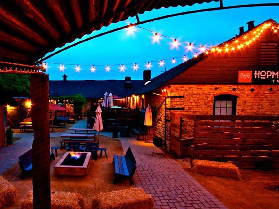 A covered patio and a fire pit at dusk