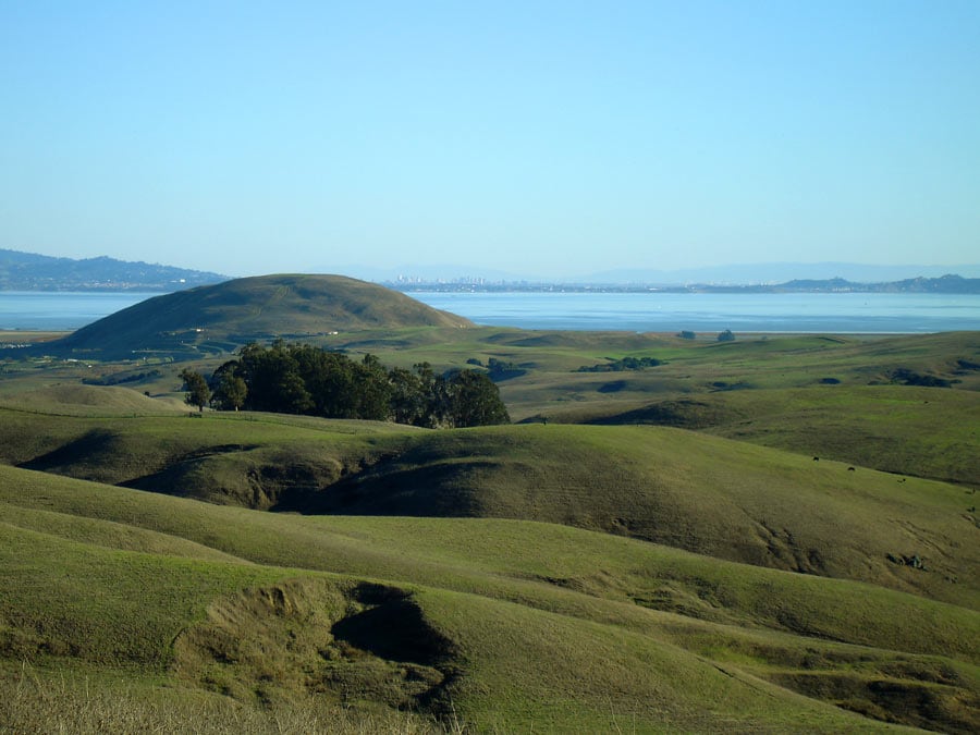 Green hills in the foreground set the stage for the views in the background where you can see for miles