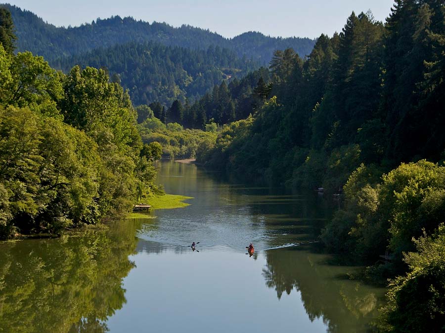 Two kayakers paddle down the Russian River in Sonoma County