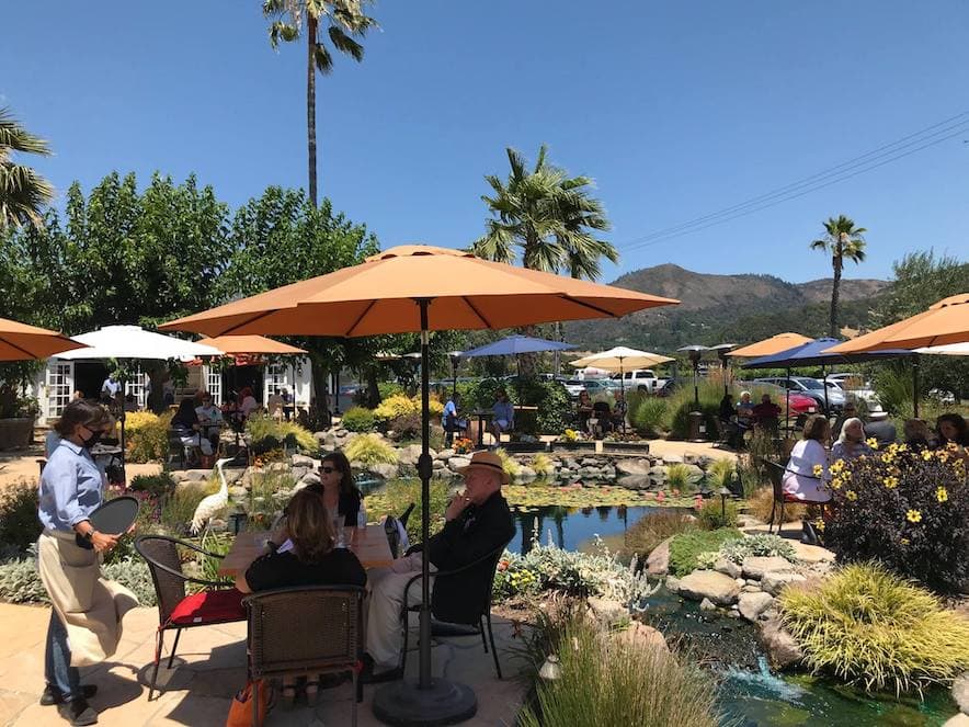 Outdoor courtyard surrounding a pond at Salt & Stone in Kenwood