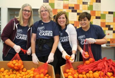 Left, Maria Dougherty of Paradise Ridge Winery, Ann Possinger of Sonoma County Orchid Society and Volunteer, Barbara Cox of Sonoma County Vintners, and Gilda Gonzalez of Sonoma County Tourism help out at Redwood Empire Food Bank.