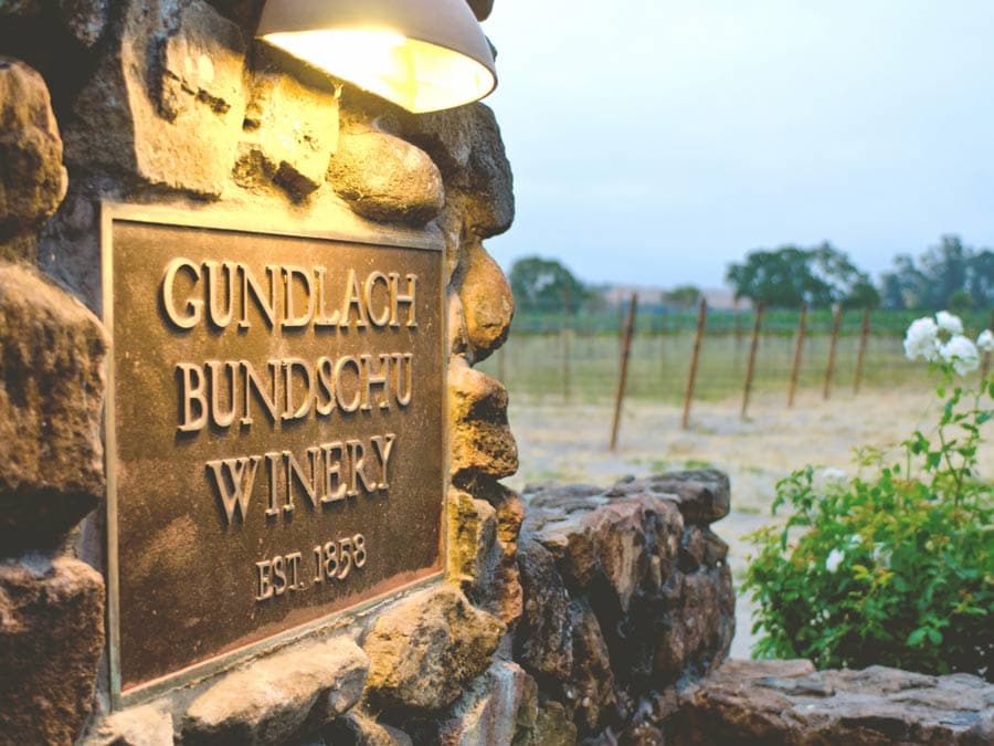 A sign on the stone pillars at the entrance to the winery