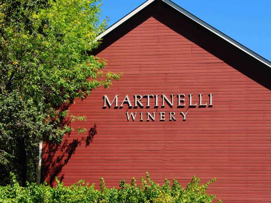 A red barn has the winery name on the side