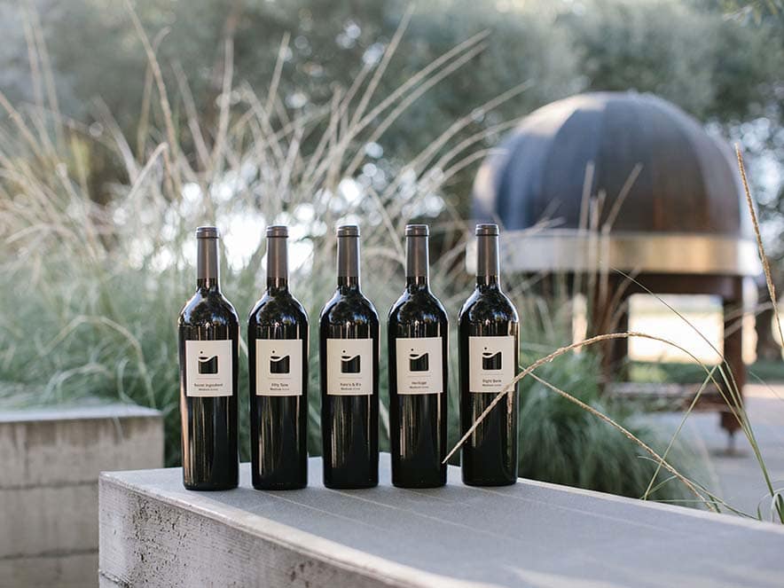 medlock ames wine bottles lined up next to each other outdoors