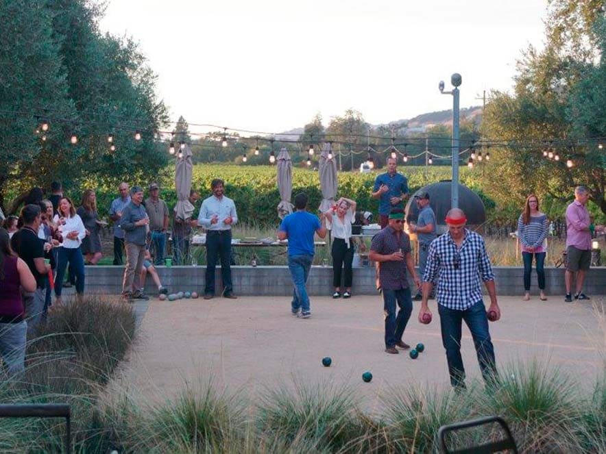 People play bocce at dusk at the rustic Medlock Ames Tasting Room, Healdsburg