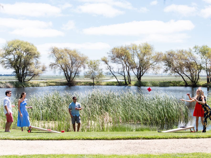 People playing games outside next to pond at Ram's Gate in Sonoma County