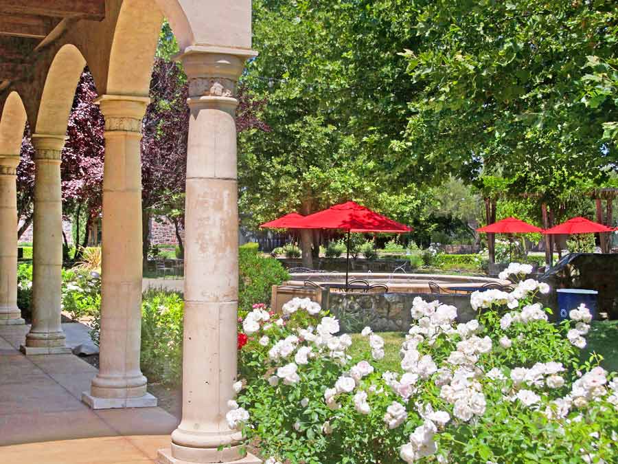 The stone courtyard outside the winery has blooming flowers