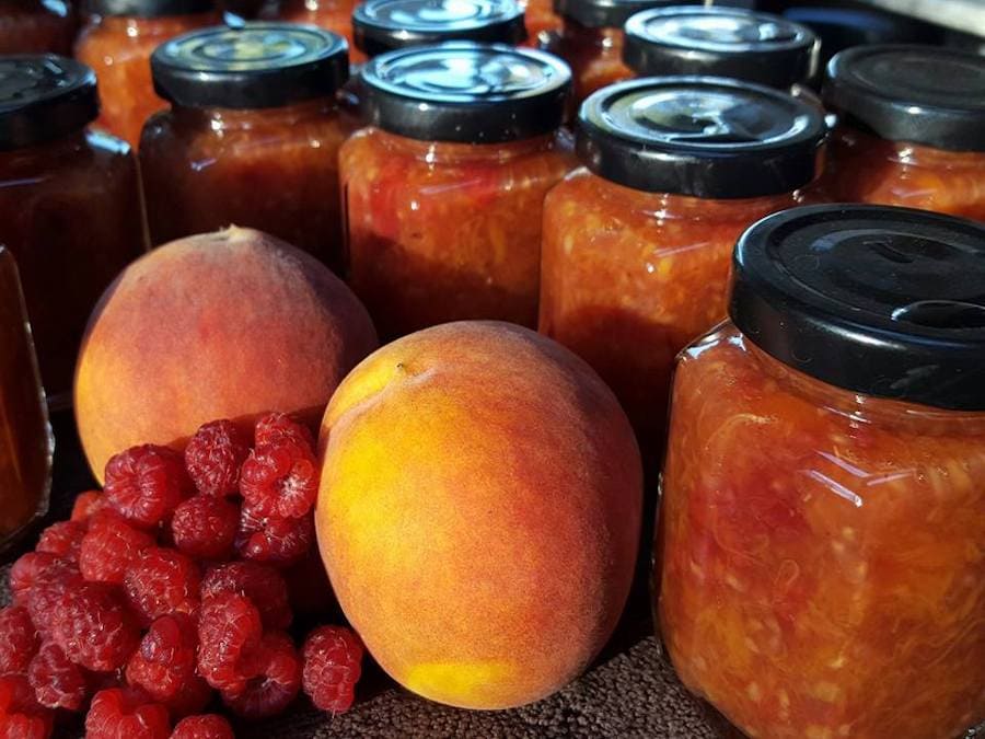 Peach and berry preserves on a shelf at Waterhorse Ridge