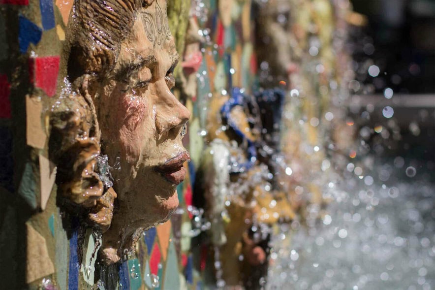 The "Faces of Petaluma Fountain" is a collection of self portraits of local citizens, who participated by sculpting their faces out of clay. The fountain was designed by Donna Billick—Photo by Robin Blaney 