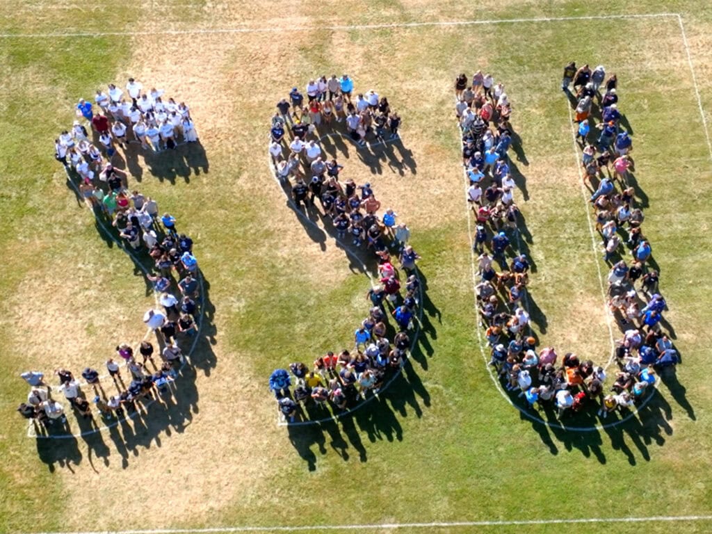 Sonoma State University students forming the letters "SSU" on a field