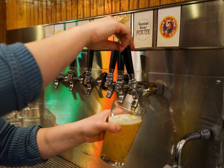 pouring beer at out a tap at russian river brewery