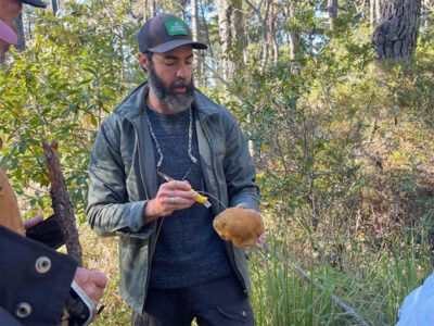 learning about how to clean the mushroom that was foraged