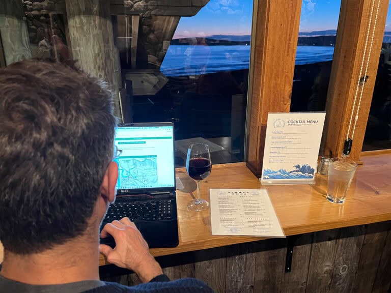 person working on this laptop while having a glass of wine in sonoma county